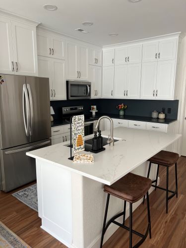 White cabinets with dark tile backsplash 